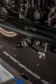 Close-up of chrome center stand mounting under a Harley-Davidson Softail